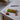 Halve-It slicer with cherry tomatoes and a knife on a concrete counter