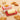 Croissant butter dish open beside a block of butter, surrounded by croissants