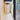 Close view of the broom head sitting inside the wall-mounted holder