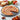 Cheese pizza with a slice removed on the perforated pizza crisper