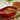 Burgundy rectangular baker filled with baked vegetables and herbs