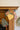 Christmas sewn garland with a bell, stocking and tree hanging from a wooden mantel