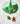 Holiday wine charms hanging on the stem of a green wine glass