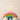 Pastel twirl candles lit on a rainbow frosted cake