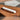 White marble rolling pin on its wood base on a wooden table