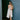 Woman with the Koko towel over her shoulder against a blue wall