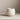 Egg Back Home Party Ball Mug in white with multicolor speckles, on a beige surface