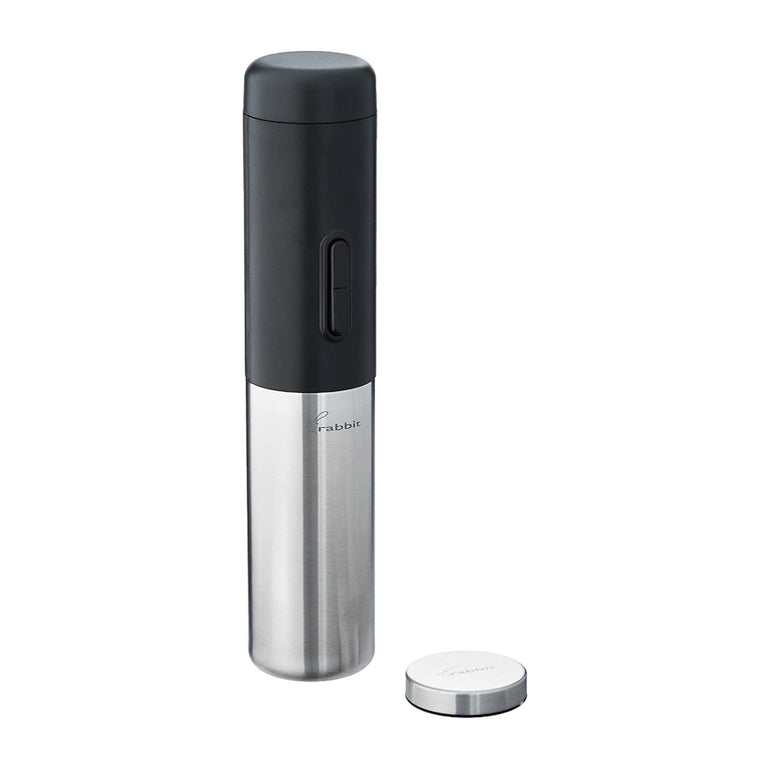 Rabbit electric corkscrew in black and brushed stainless steel, standing upright beside its round stainless foil cutter