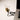 Gold-based lightbulb connected to a laptop by a black USB cable on a desk