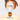 Hand pinching a glowing filament lightbulb with a gold base above a pale surface