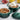 Le Creuset mini souffle cocotte in artichaut green, 8oz, showing a colorful ceramic dish with a smooth, rounded shape and glossy finish.