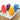 Four dinosaur shaped ice pops in red, purple, yellow and blue on coconut flakes