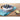 Round gray cake pan holding a frosted cake topped with blueberries on a teal towel