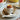 Soft-boiled egg in an RSVP white porcelain hen egg cup with toast soldiers and an egg spoon on a saucer