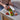 Hands running a knife through the Halve-It slicer to cut tomatoes