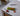 Halve-It slicer with cherry tomatoes and a knife on a concrete counter