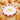 Croissant plate on a peach surface surrounded by croissants