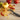 Kuhn Rikon swivel peeler on a cutting board with apple peels and a zucchini