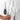 Hand removing a knife from the Yamazaki Tower Magnetic Knife Rack in white