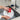 Beardy gnome dish brush held in hand while scrubbing a pot