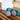 Two grey wool dryer balls beside a blue felt storage bin on a wood counter