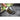Outset 3-in-1 grill brush in use cleaning grates