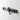 Yamazaki Tower Magnetic Knife Rack in black mounted on a bathroom wall holding hair accessories
