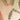 Paper Christmas crackers strung on thread against a light wall