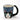 Cosmos Gifts blue mug with a black and white cat face peeking over the front and a black cat-tail handle