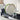 Extend dish rack holding plates, glasses and utensils beside a sink