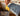 Yellow bristle comb pulling dust from the broom head