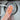 Hand holding a Full Circle copper scrubber over a sink