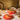 Le Creuset 4.5-quart round Dutch oven in vibrant color, featuring a sturdy handle and smooth enamel finish.