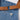 Close up of the brass strap hardware and pocket label on the denim apron