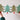 Hands holding up the Christmas Trees concertina garland of four patterned green trees