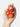 Hand holding the red sweater teddy bear shaker