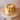 Layer cake topped with caramel popcorn on the white Party Cake Stand