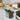 Full Circle Scrap Happy slate compost bin hung on a drawer front below a cutting board of vegetables