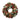 Round wreath of frosted pinecones, pine sprigs, red berries and red ball ornaments