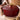 Hands holding the Garnet Holiday Tree Dutch oven with a towel