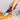 Hand using the Ototo Kitty-Cut to slice a pizza, lifestyle