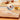 Kuchenprofi tweezer tongs on a wooden board with a close-up of the grip