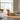 Decorative milk carton and butter box on a table with a blurred background
