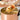 Medium Spoon lifting noodles, chicken and carrot from a pot of soup