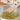 Angled Turner stirring diced shallots in a pan
