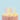 Eight pastel twirl candles lit on a sprinkle-covered birthday cake