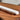 White marble rolling pin on its wood base on a wooden table