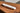 White marble rolling pin on its wood base on a wooden table