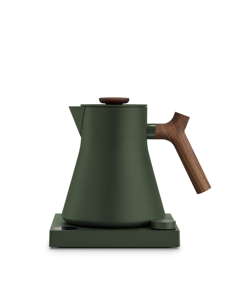 Fellow Corvo EKG Pro electric kettle in dark green Woodland with a walnut handle and lid pull, on its base