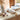 Calico Meowmbrella in its cat-shaped case lying on a sideboard